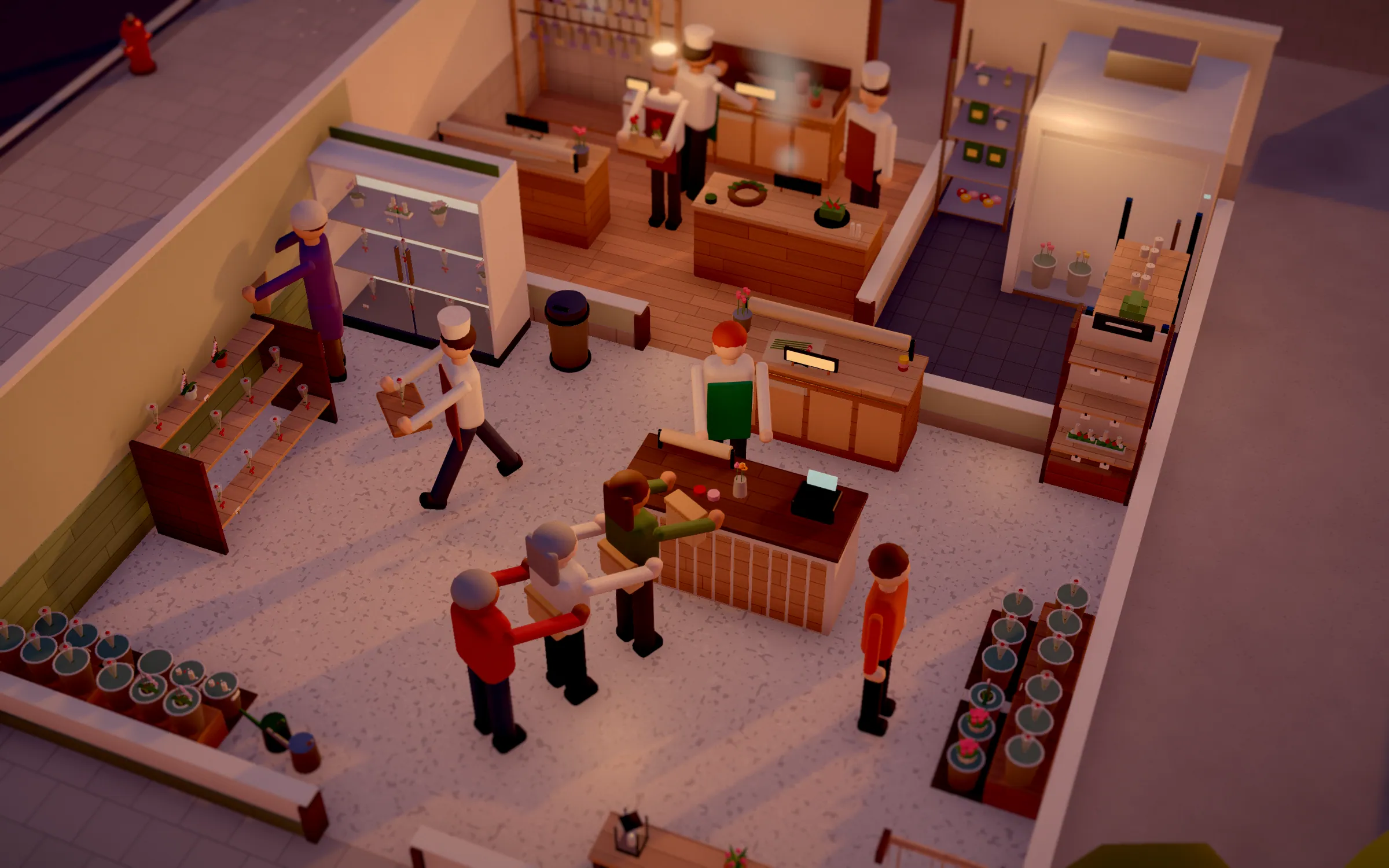 Florist from above with binding table, flower buckets and a fridge for cut flowers