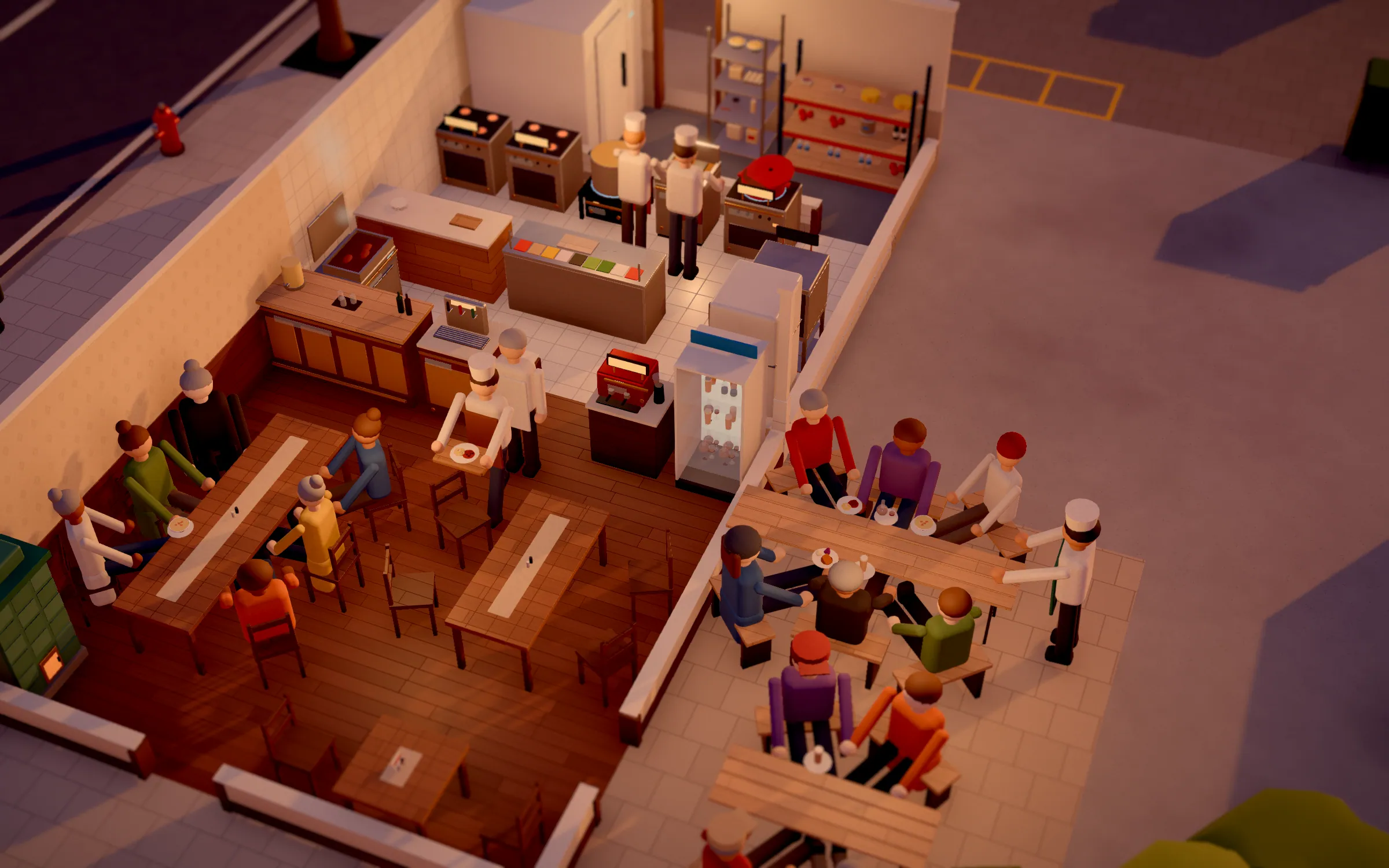 Restaurant from above with dining room, groups at long tables and a kitchen