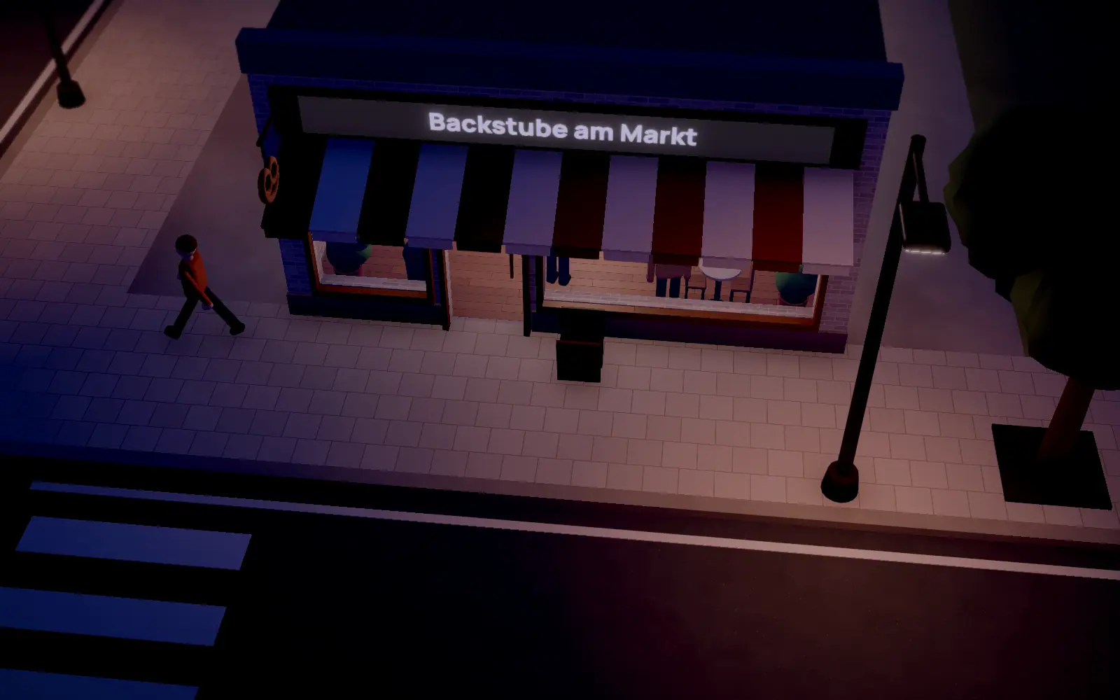 A shop on the market square at night, lit by street lamps